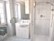 Upstairs bathroom with toilet, bidet, shower, basin and storage. 